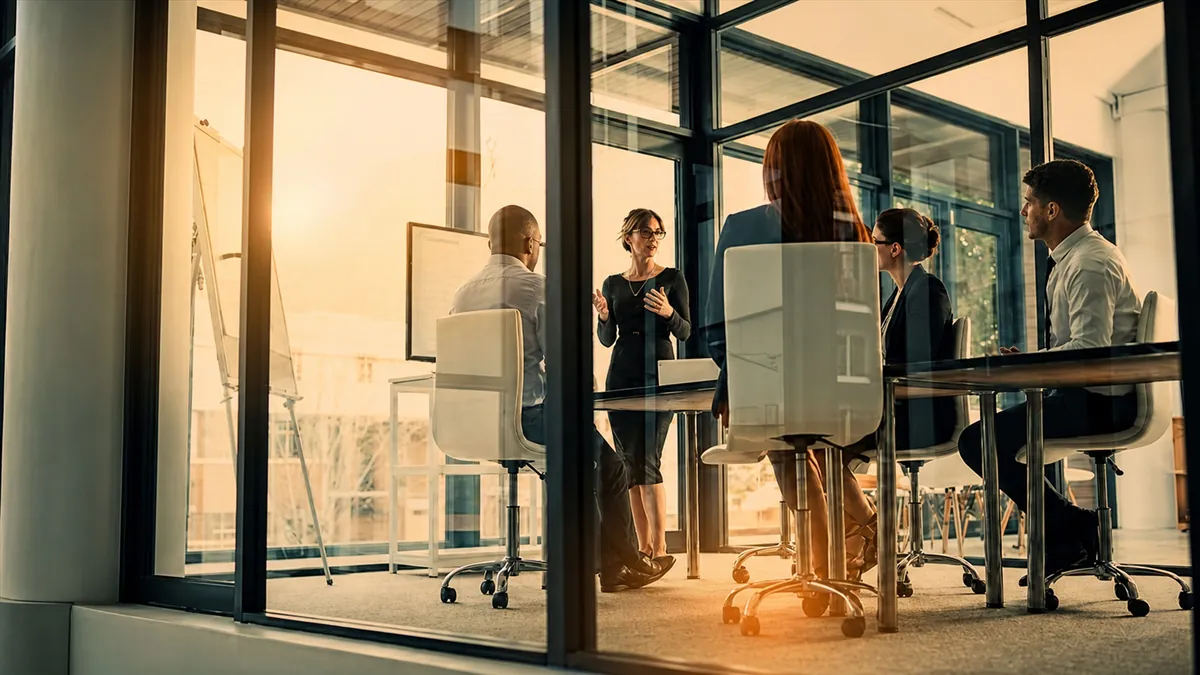 Business team inside glass conference room
