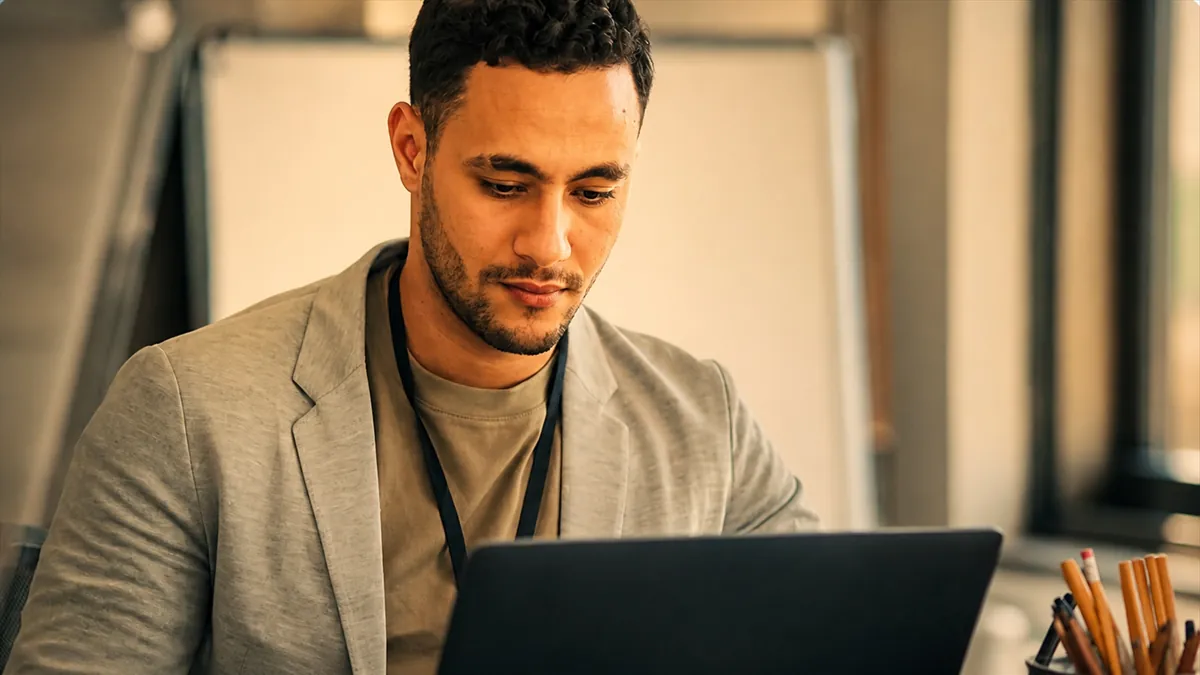 Man working on laptop in home office