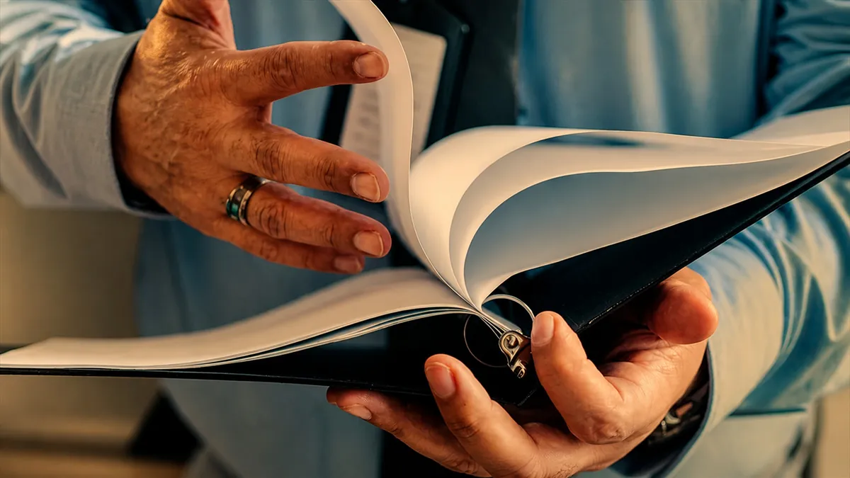 Person reading open book close up