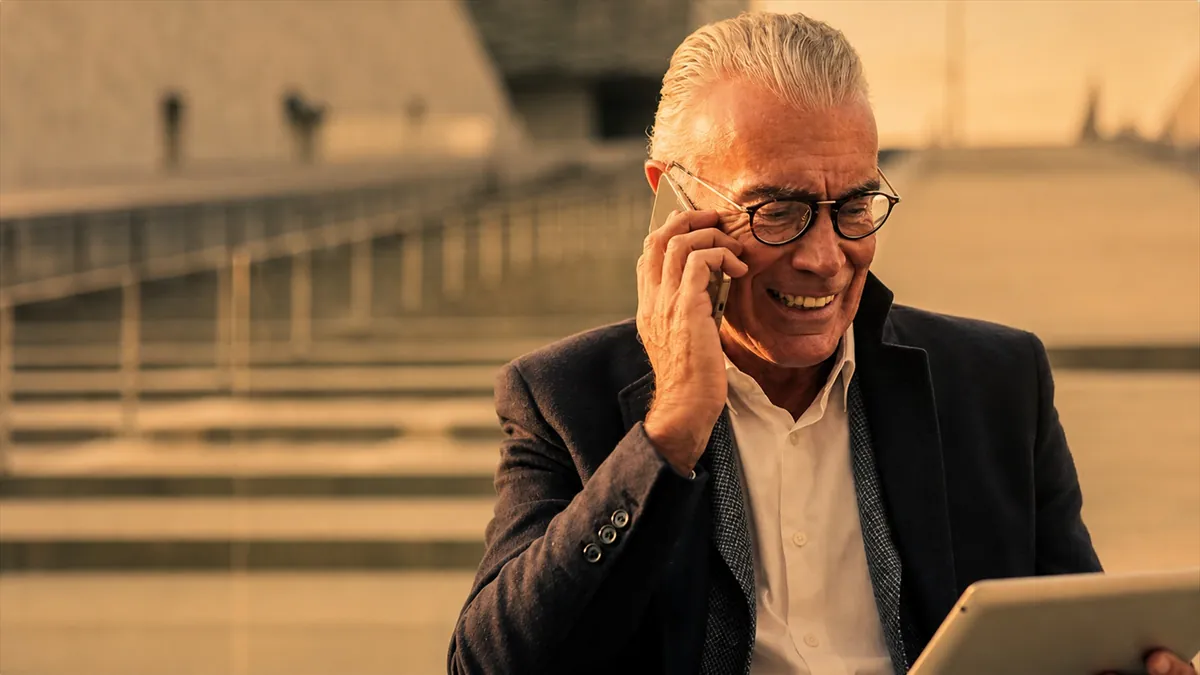 Senior businessman talking on phone outdoors