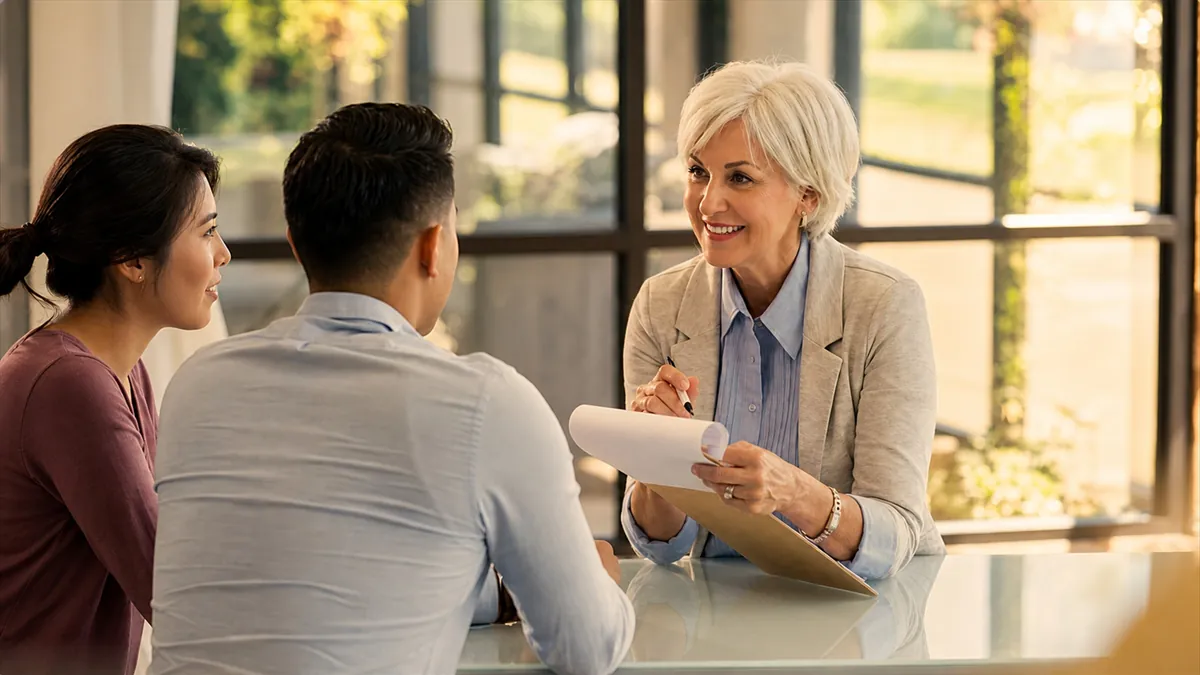 Senior financial advisor meeting couple