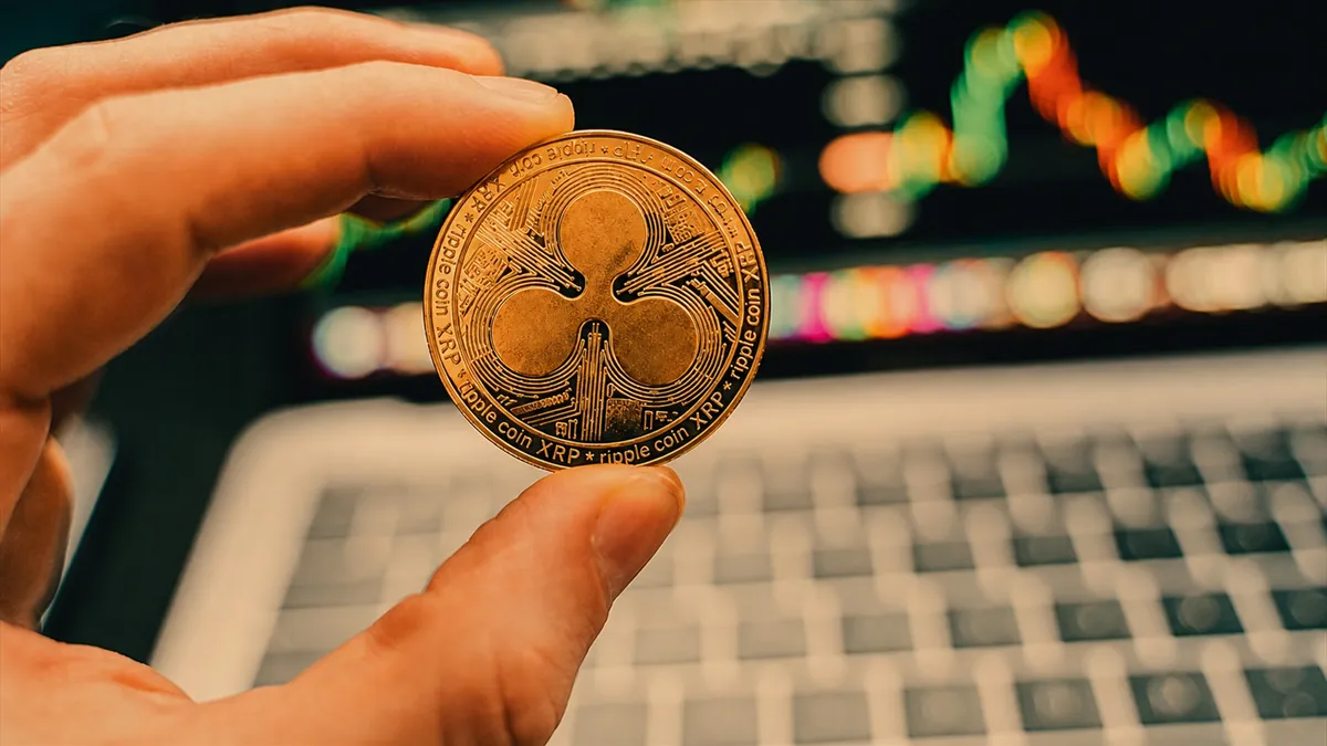 XRP coin held before crypto price chart